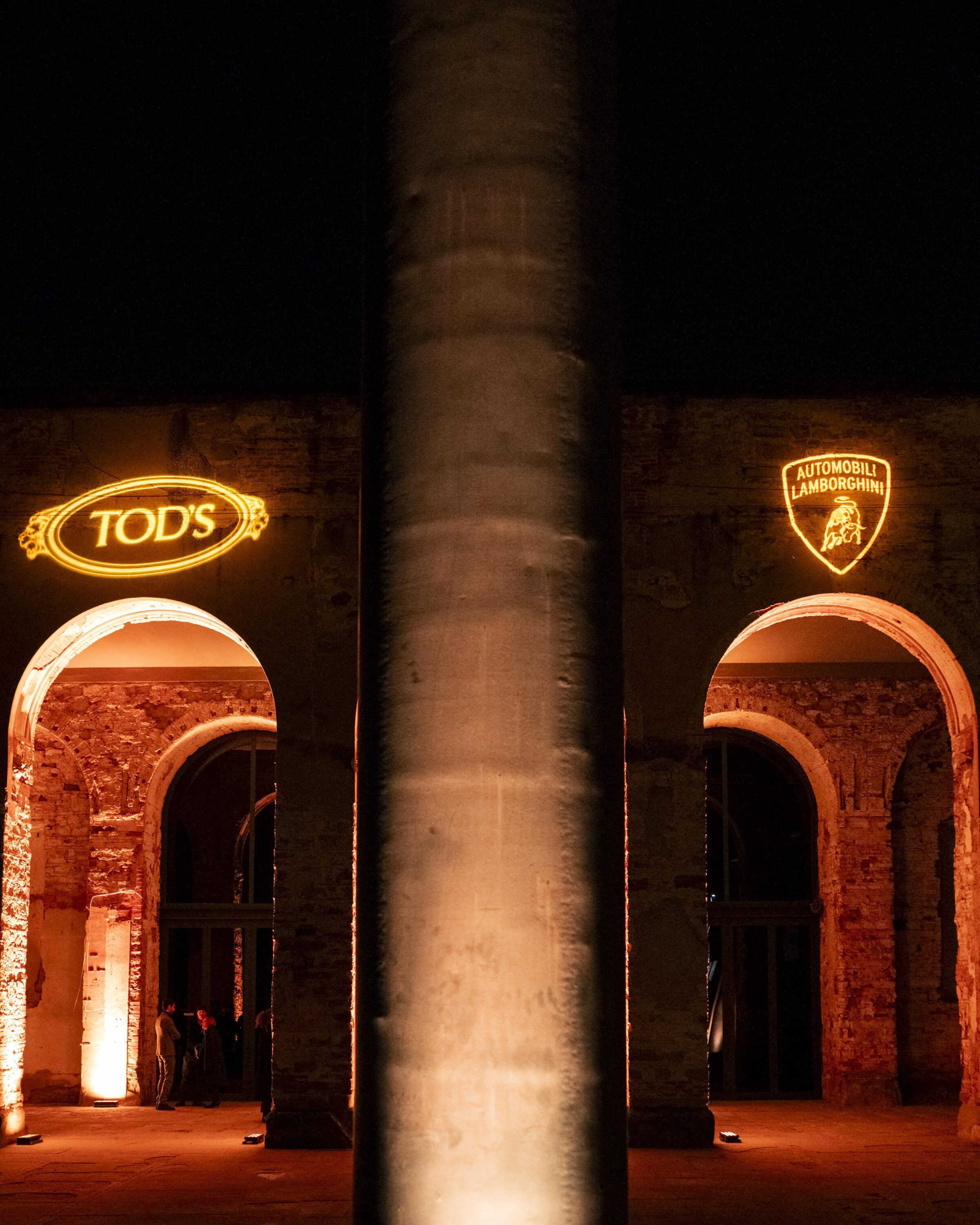 Lamborghini and Tod's logos lit up in neon at Pitti Uomo 2024.