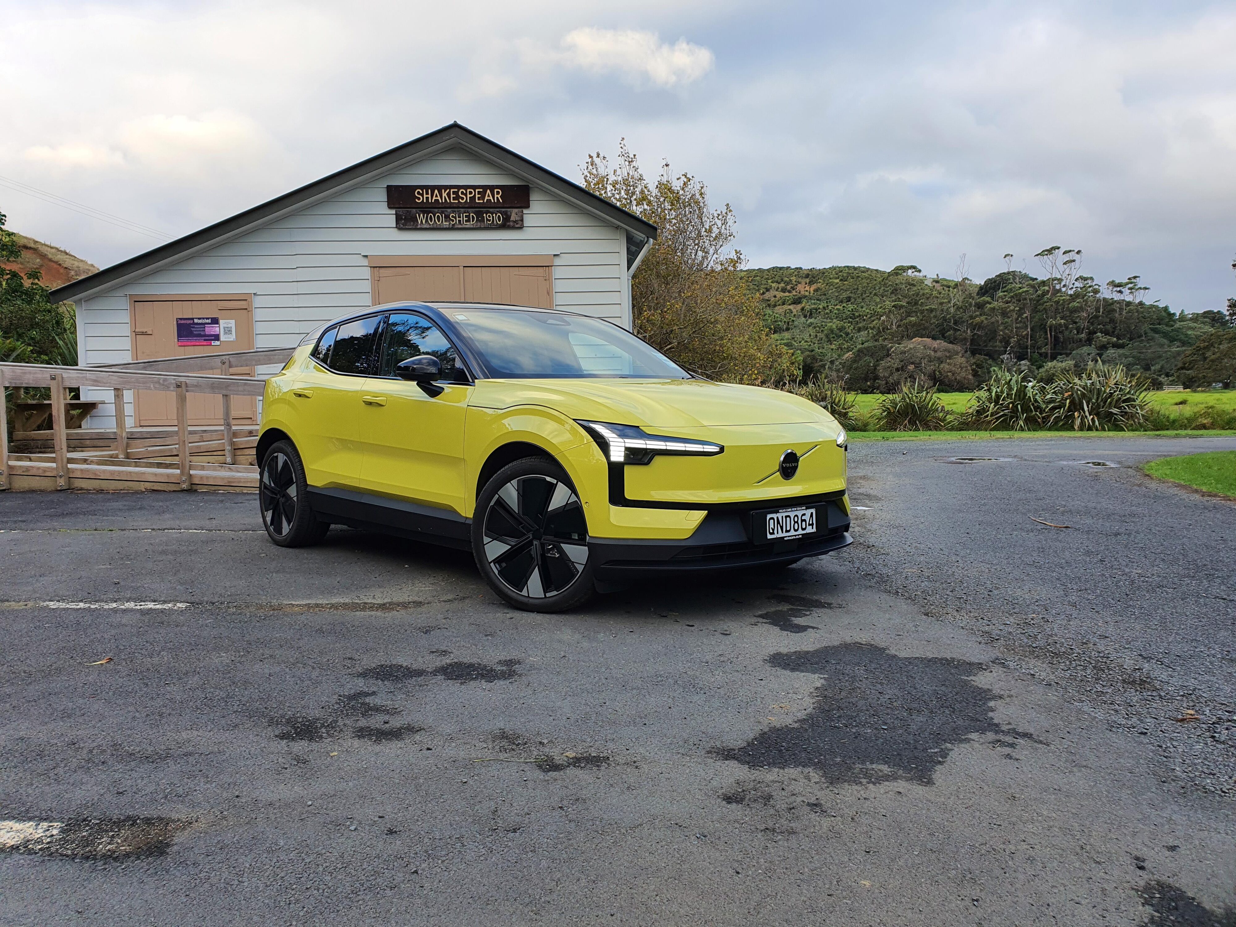 Front three quarters view of a 2024 Volvo EX30 in Moss Yellow.