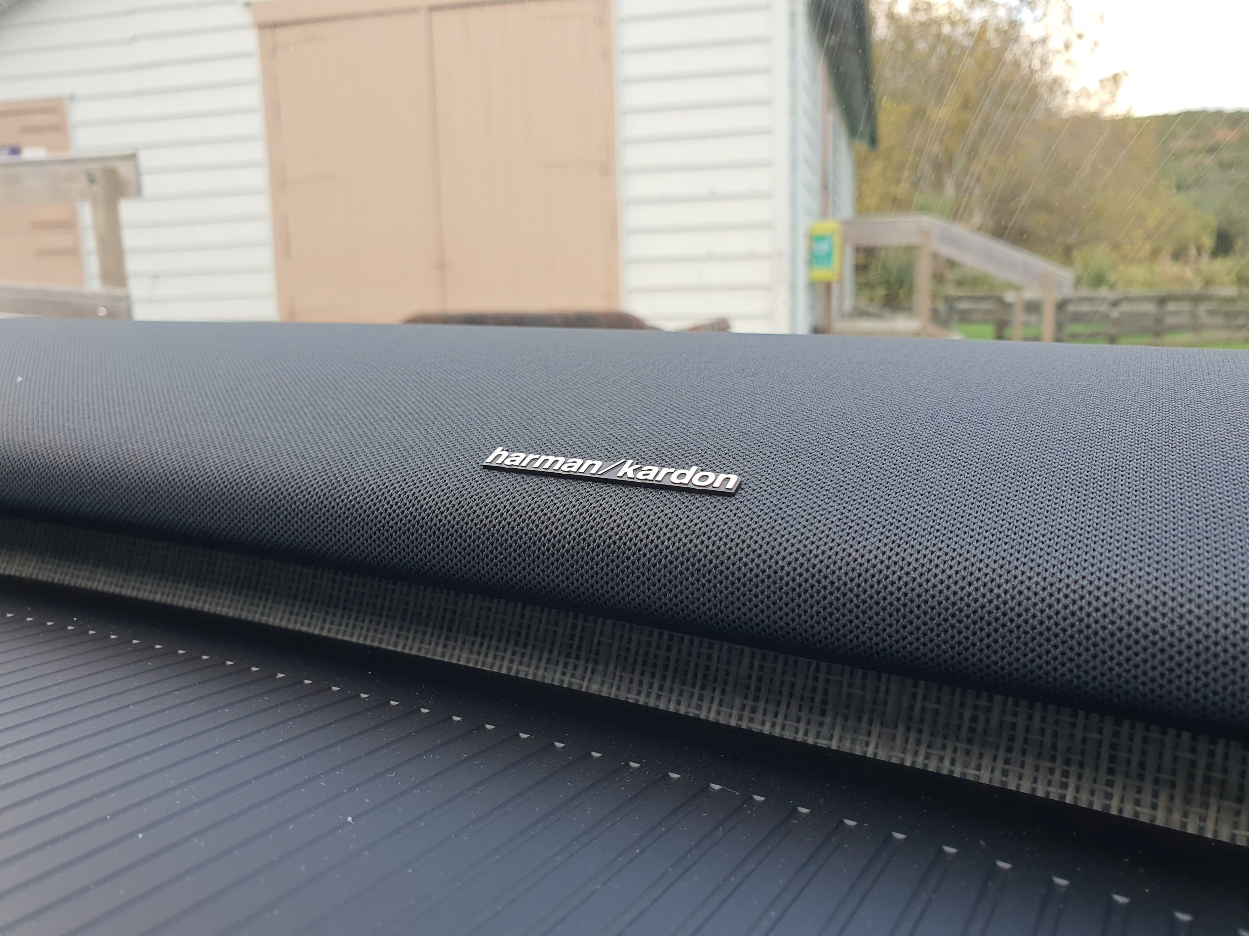 Harman Kardon logo on the Harman Kardon soundbar on the interior of a 2024 Volvo EX30 in Moss Yellow.