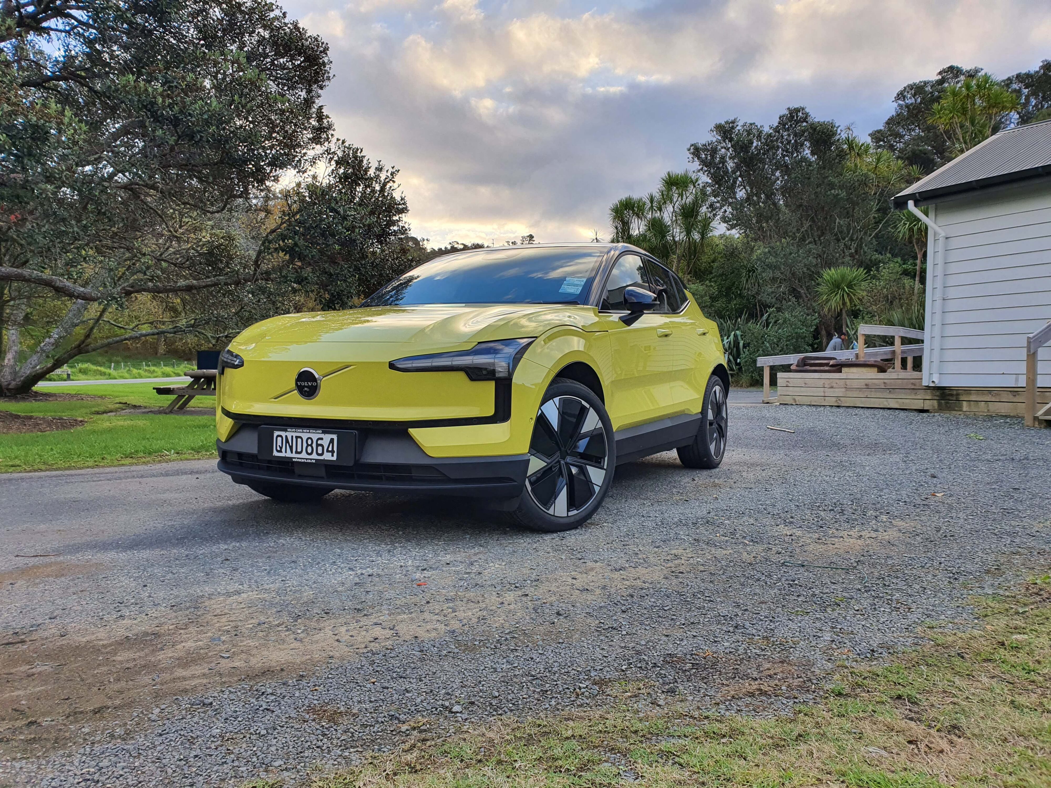 Front three quarters view of a 2024 Volvo EX30 in Moss Yellow.