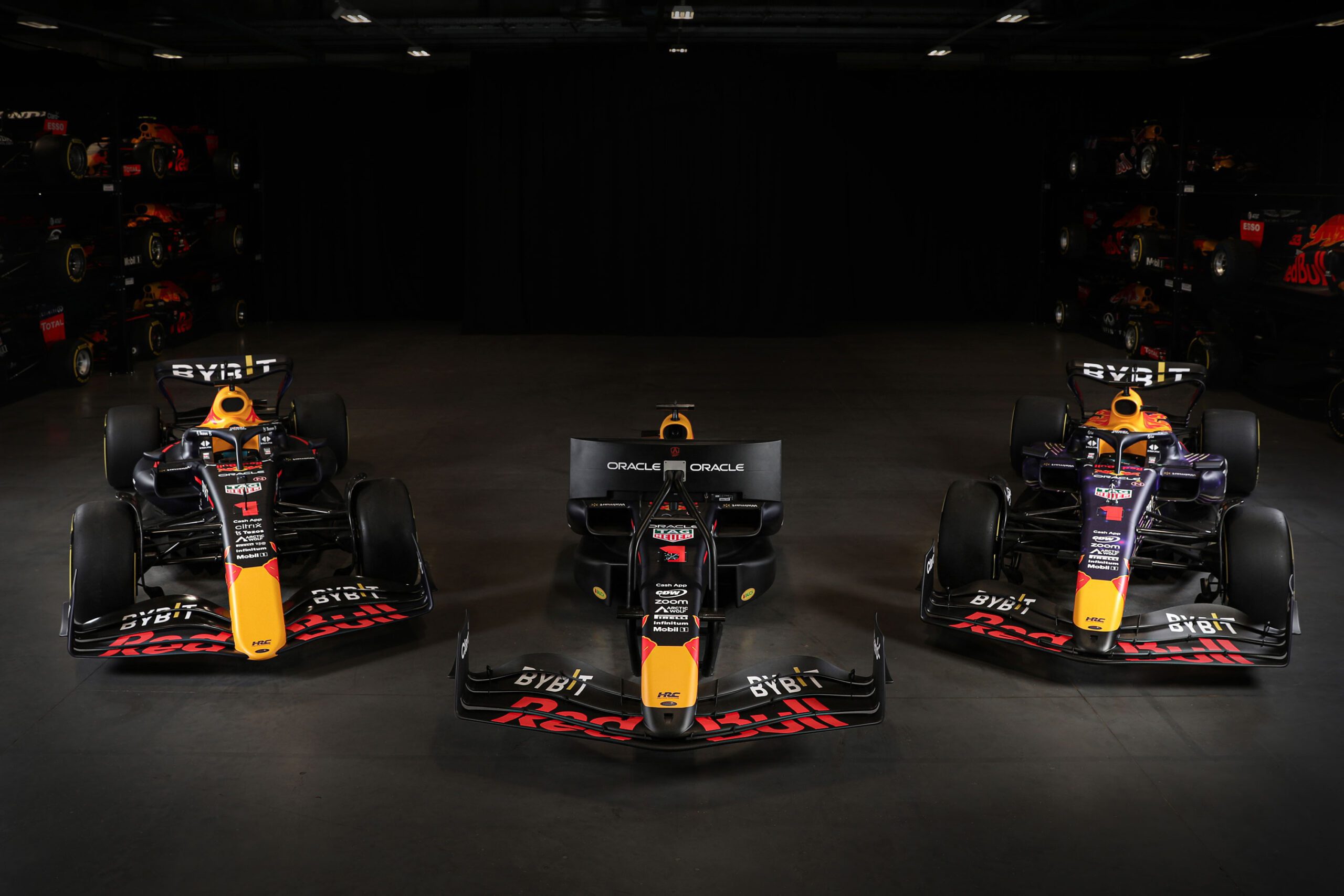 A photo of a Red Bull Motion Simulator flanked by two Red Bull Racing F1 Show Cars.