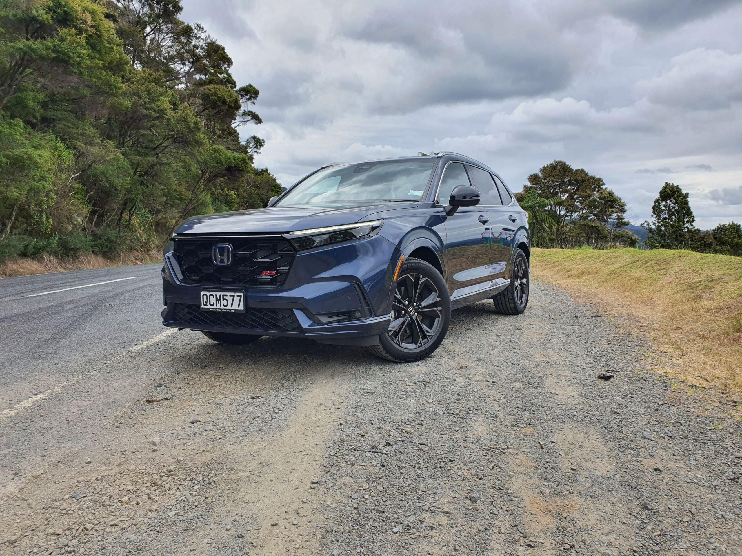 Front three quarters view of a 2024 Honda CR-V RS e:HEV in Canyon River Blue Metallic.