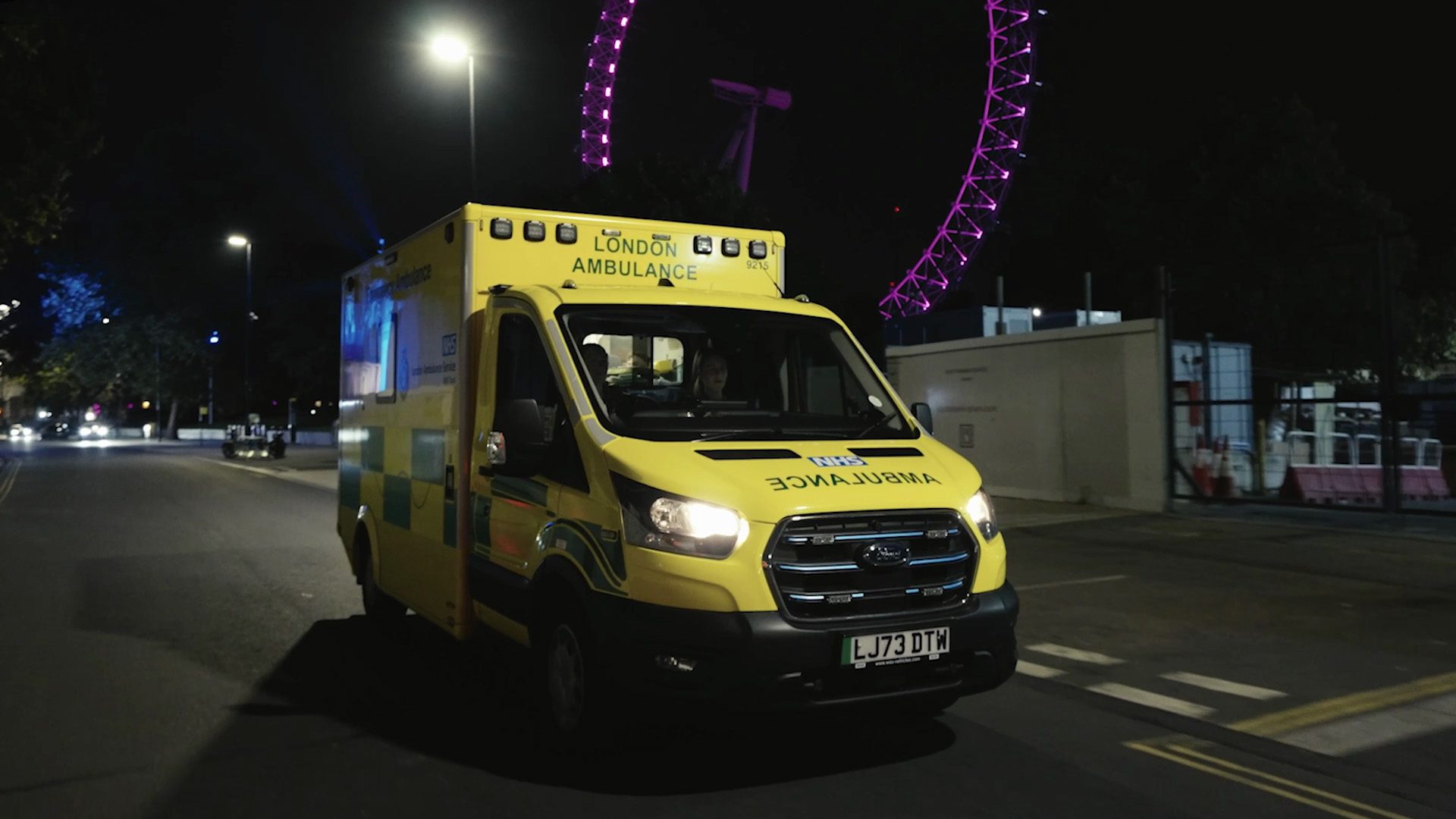A Ford Pro EV Ambulance on the streets of London at night.