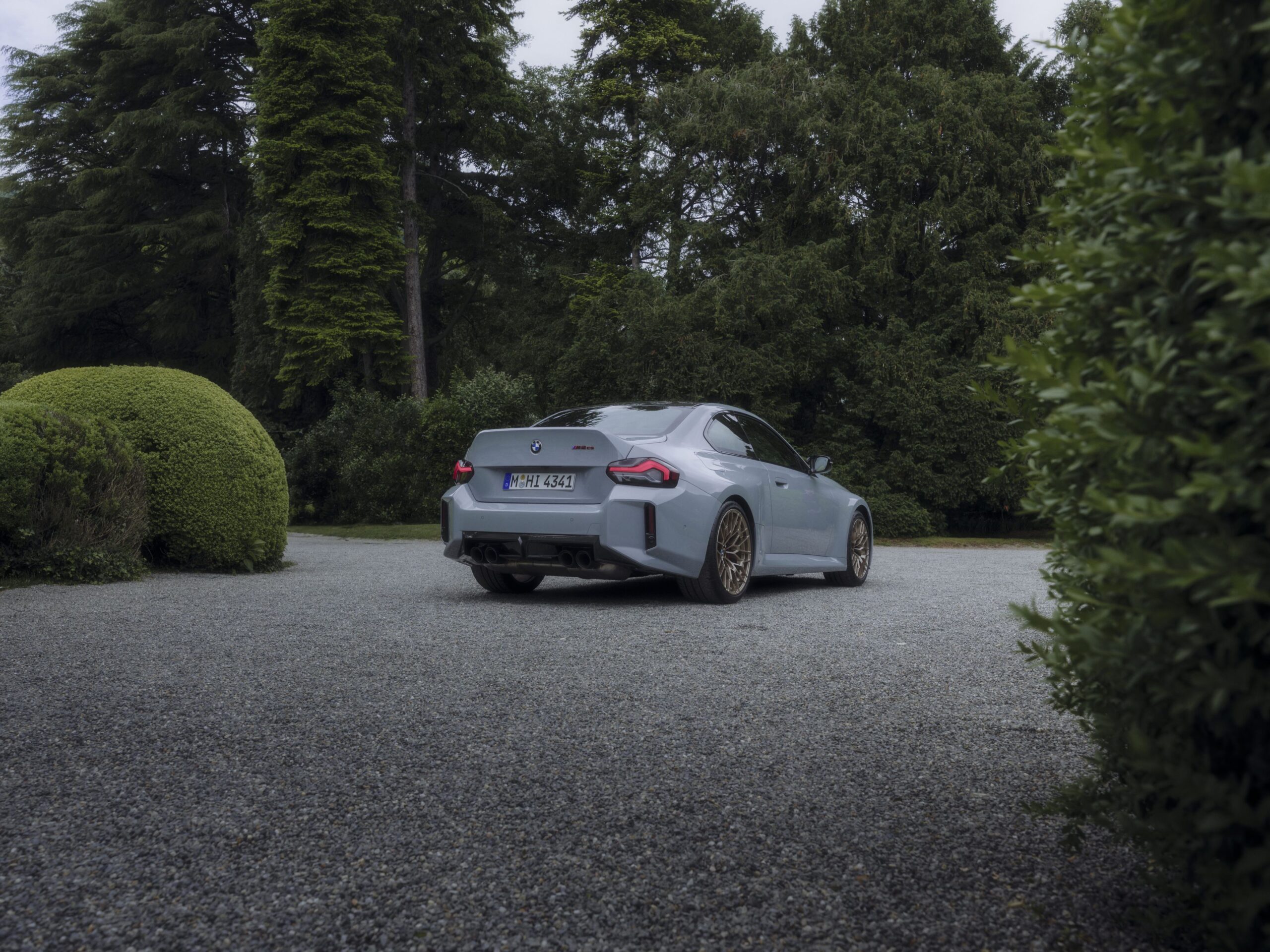 Rear three quarters view of a 2025 BMW M2 CS in grey at Villa d'Este Concorso d'Eleganza.