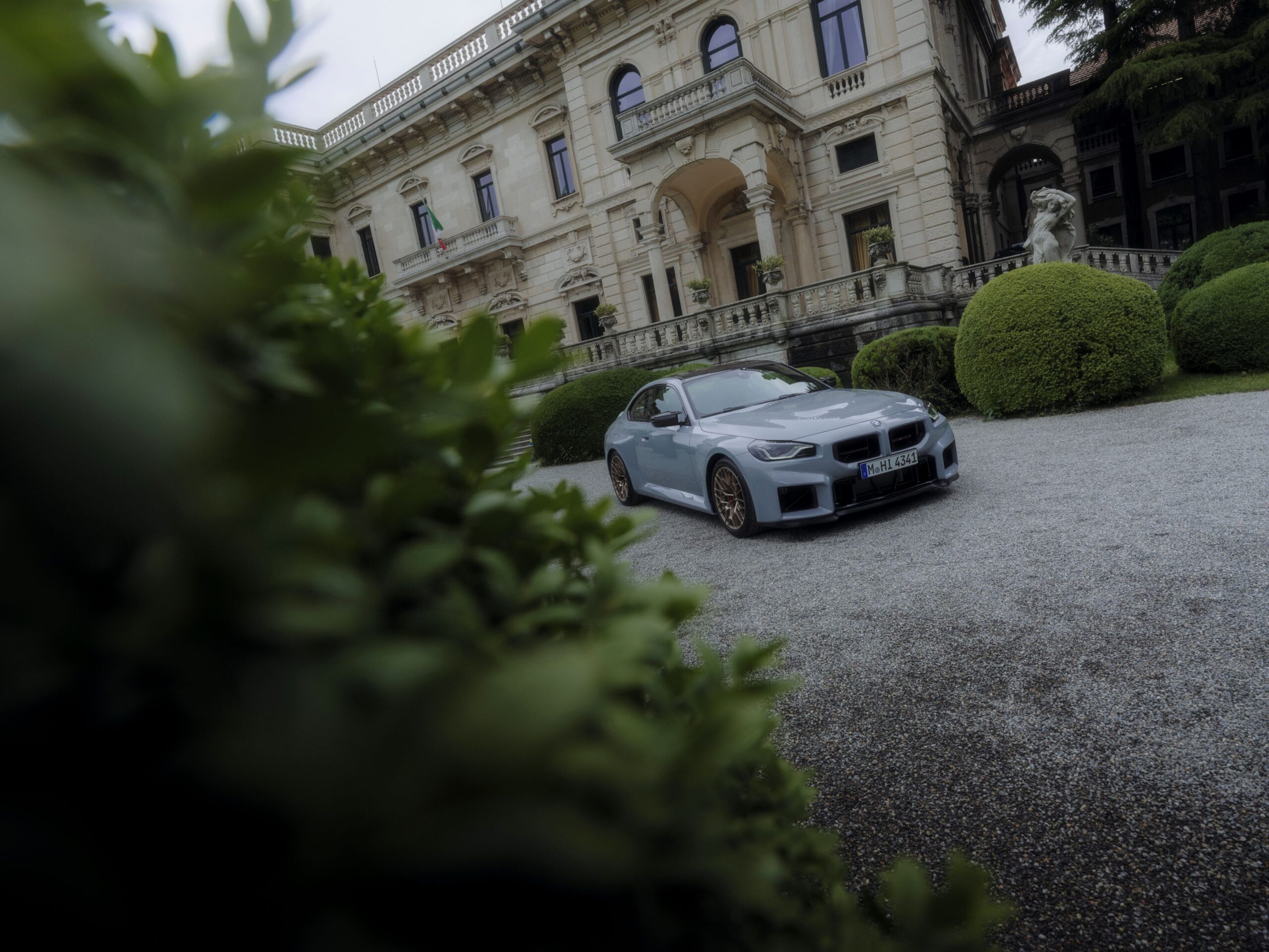 Front three quarters view of a 2025 BMW M2 CS in grey at Villa d'Este Concorso d'Eleganza.