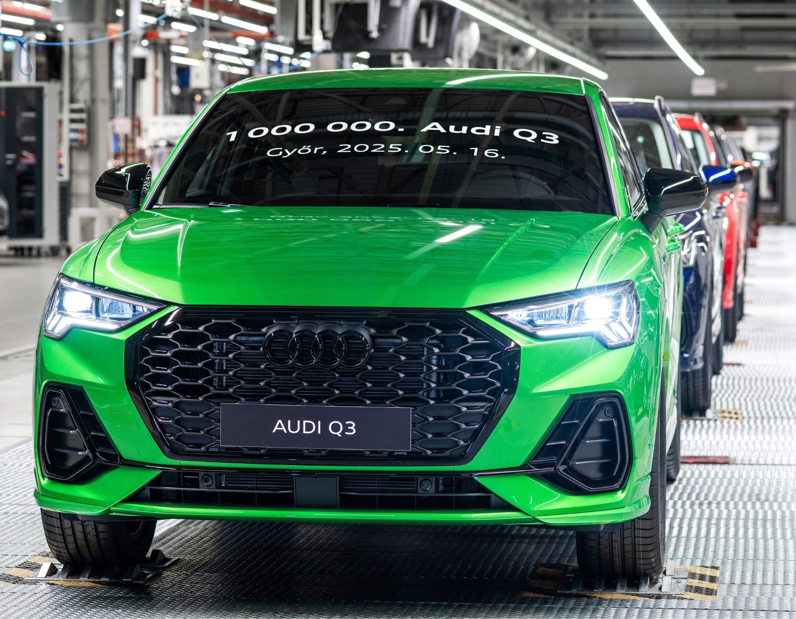 Front three quarters view of the one millionth Audi Q3 produced at the Gyor plant in Hungary. The car is painted in bright green.