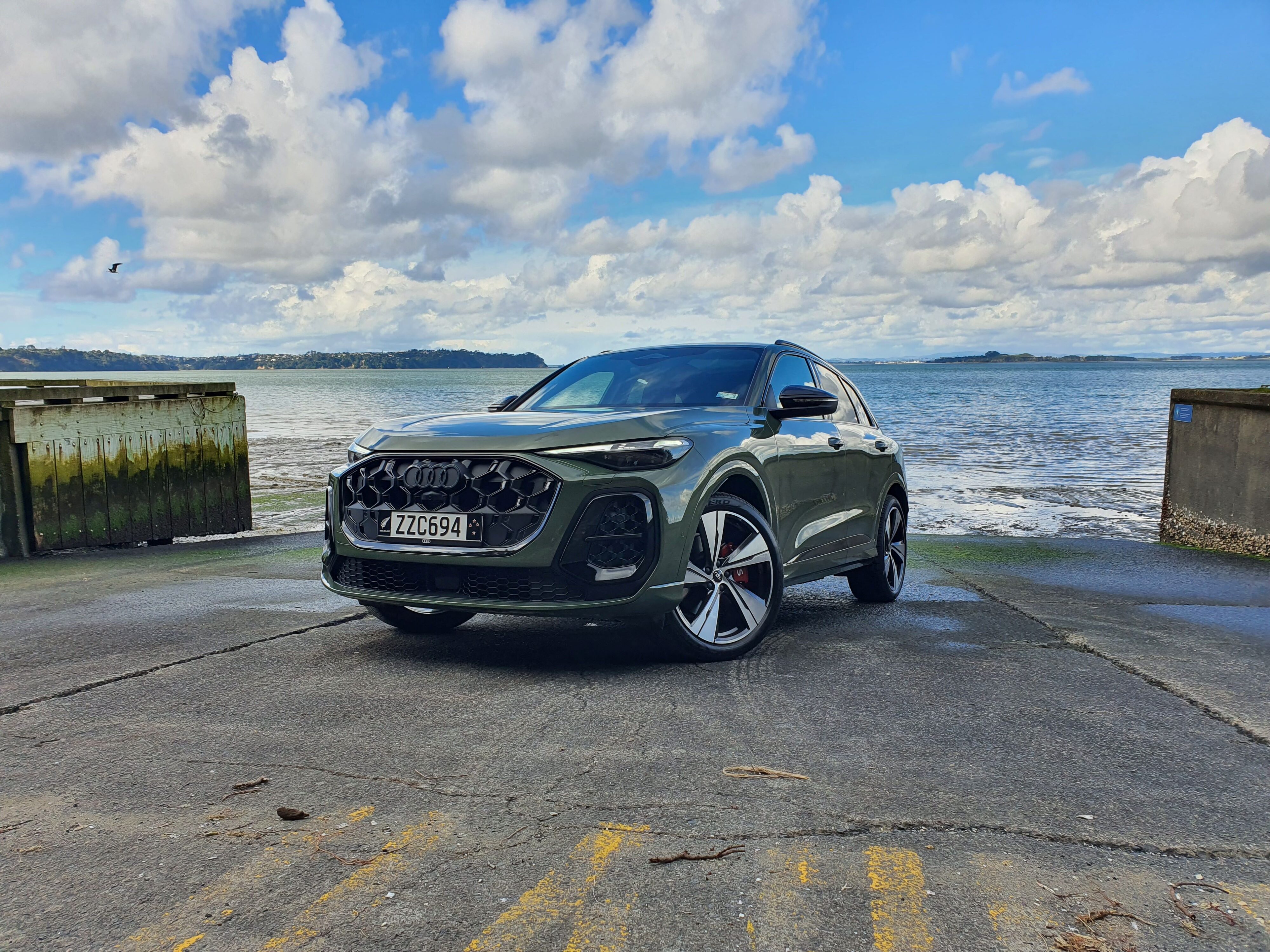 Front three quarters view of a 2025 Audi SQ5 in District Green.