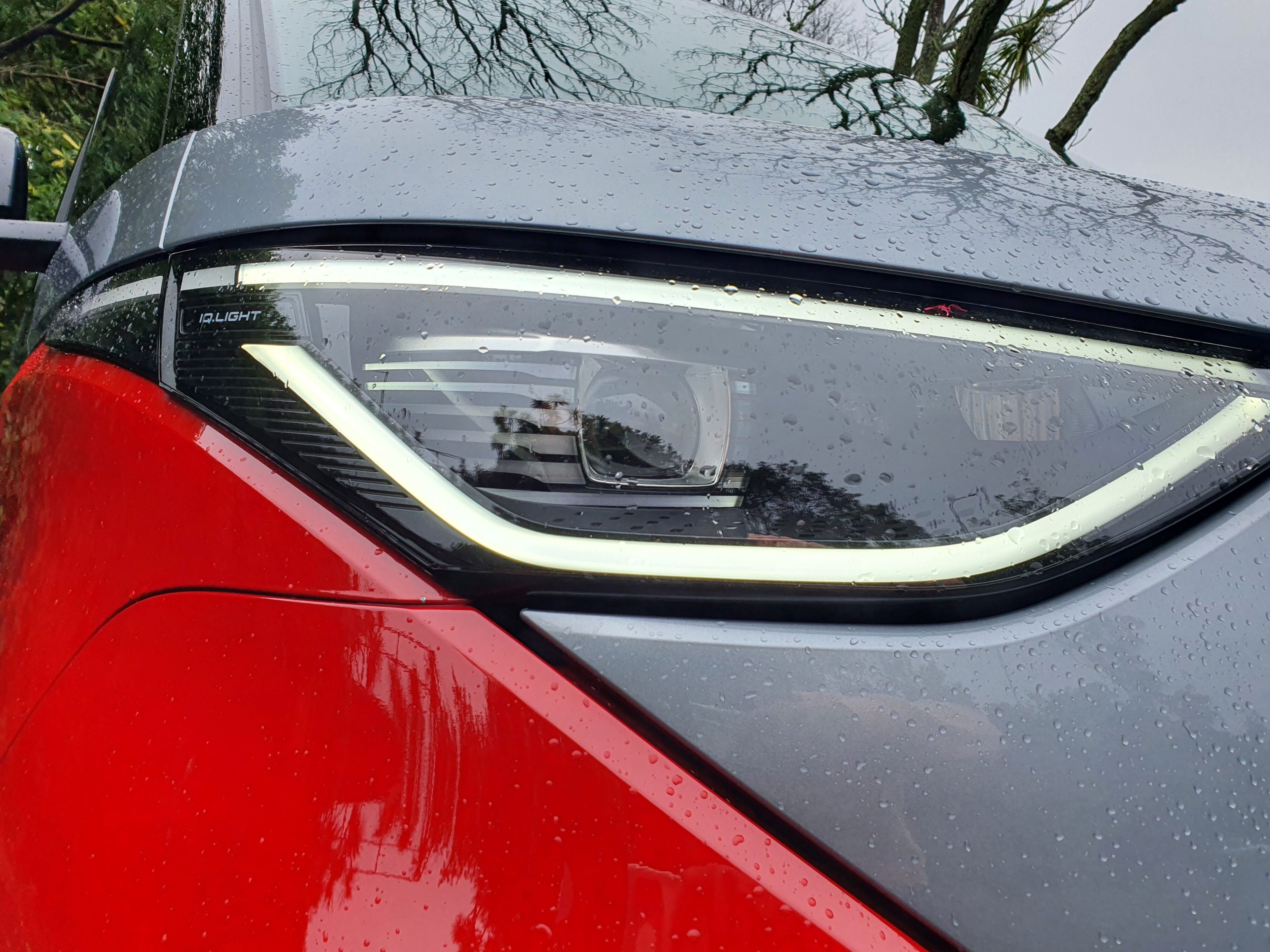 Front right headlight of a 2025 Volkswagen ID.Buzz GTX in red and silver.
