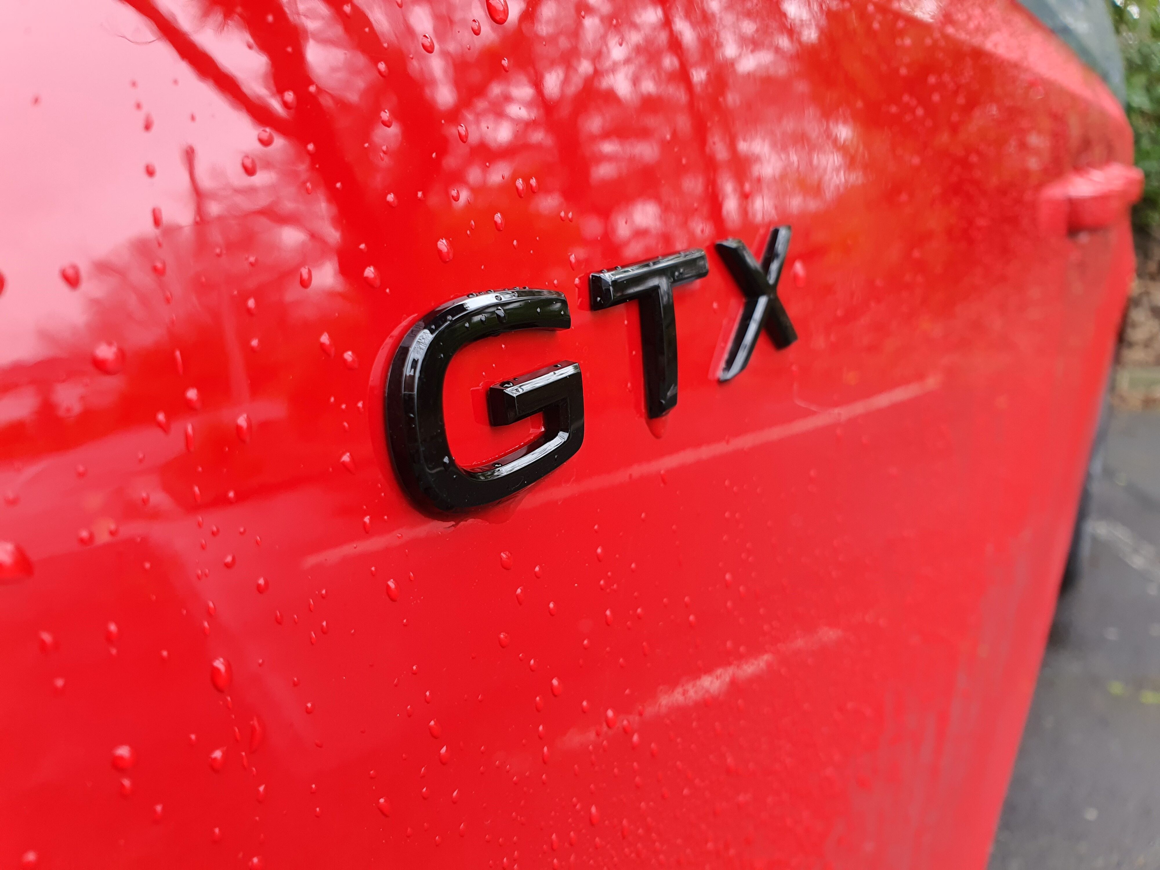 GTX badge on a 2025 Volkswagen ID.Buzz GTX in red and silver.