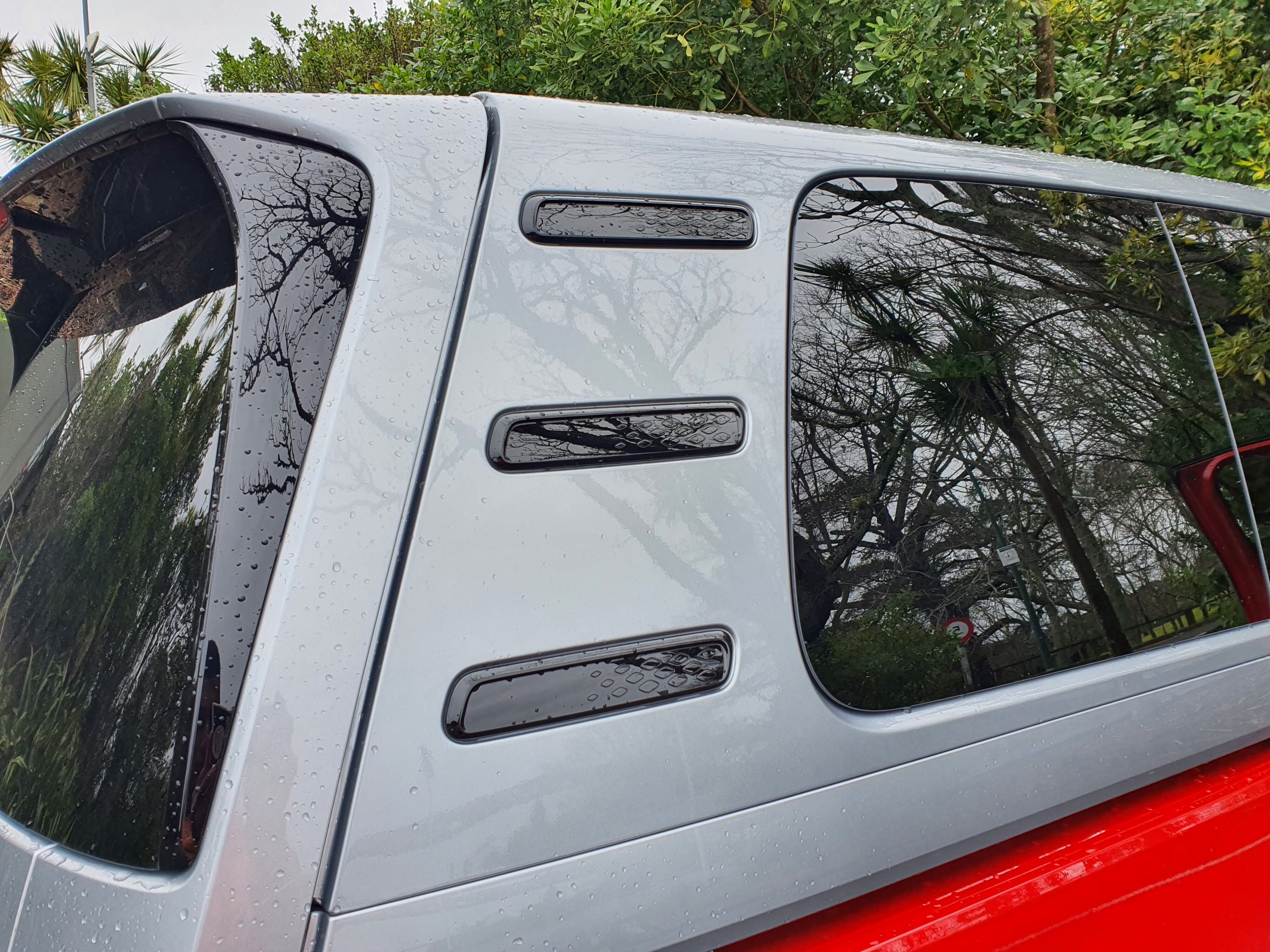 Rear three quarter panel of a 2025 Volkswagen ID.Buzz GTX in red and silver.