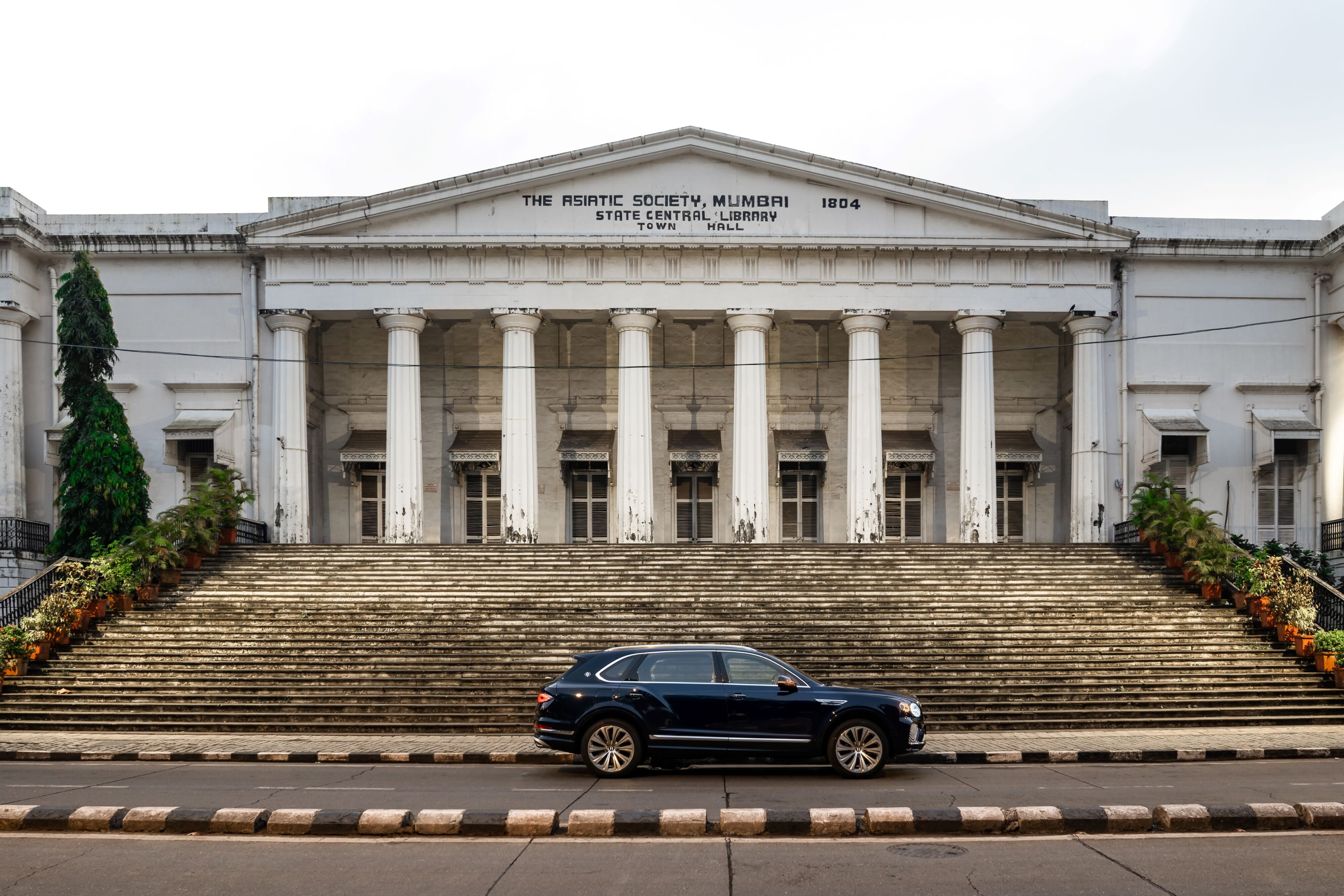 A photo of the Bentley Bentayga EWB outside the Asiatic Society Building in Mumbai, India.